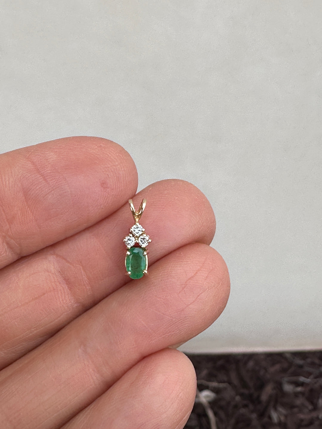 14 Karat yellow gold diamond and emerald pendant