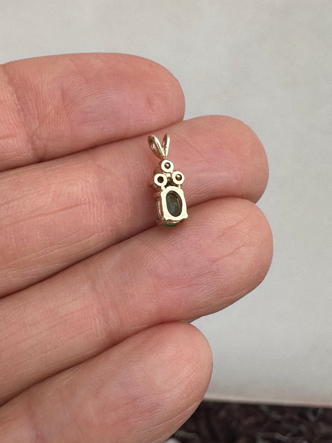 14 Karat yellow gold diamond and emerald pendant