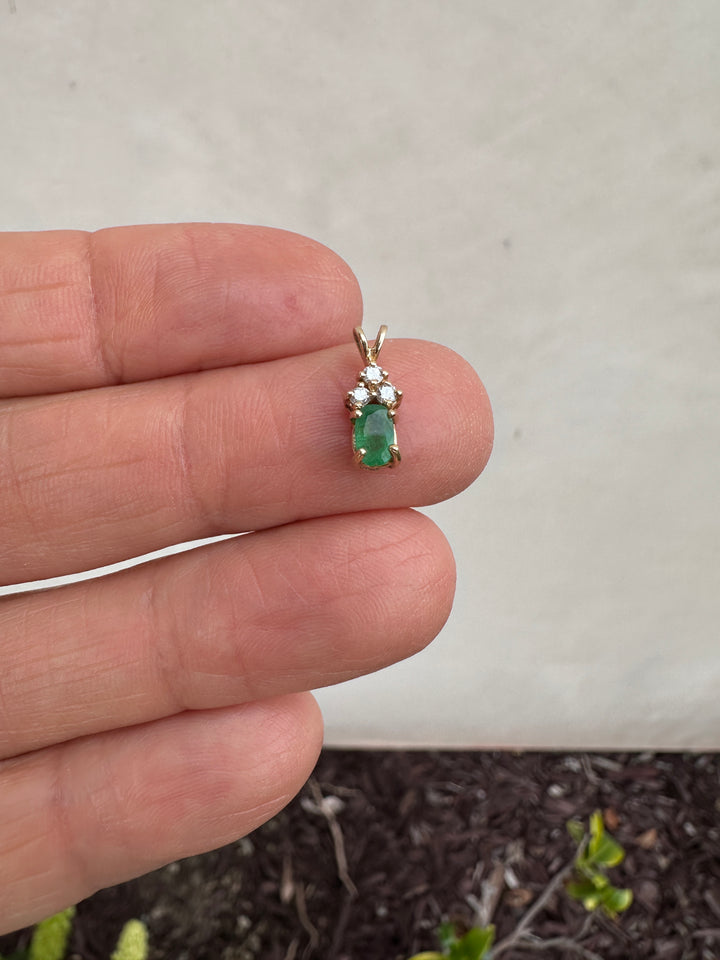 14 Karat yellow gold diamond and emerald pendant