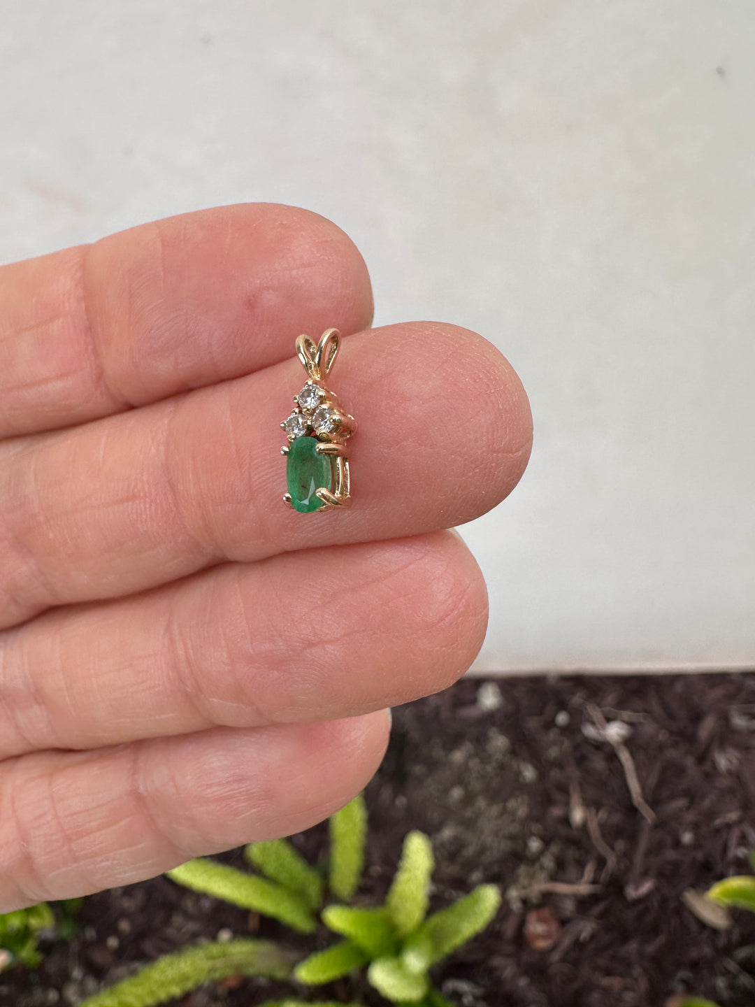 14 Karat yellow gold diamond and emerald pendant