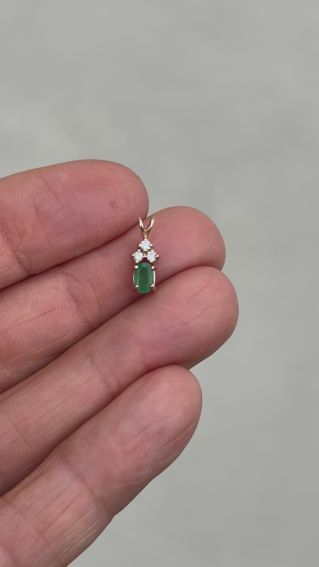14 Karat yellow gold diamond and emerald pendant